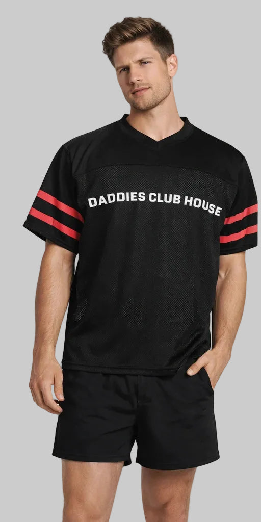 Man wearing a black sports jersey with 'DADDIES CLUB HOUSE' text on a white background