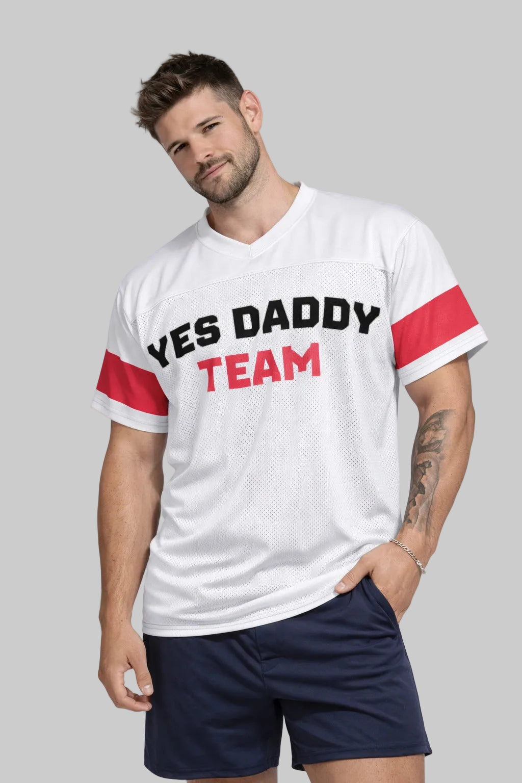 Man wearing a white t-shirt with 'YES DADDY TEAM' text and red sleeves on a plain background